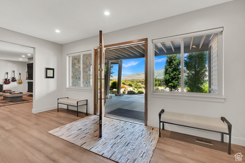 Entryway featuring wood finished floors, baseboards, and recessed lighting