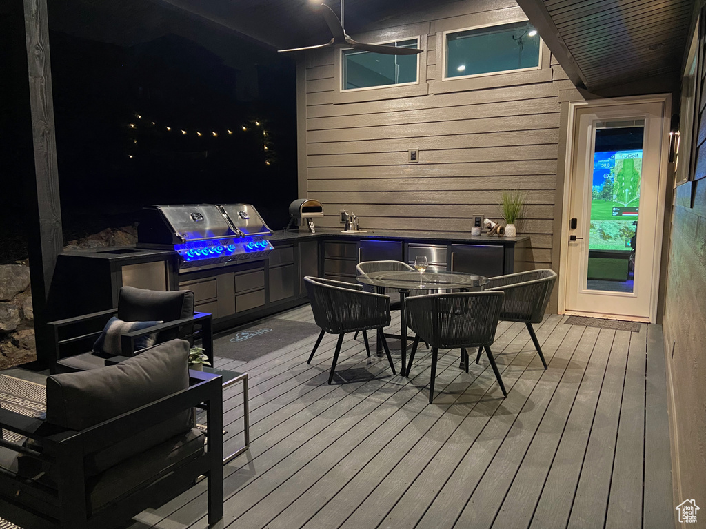 Wooden deck with a grill and outdoor dining space