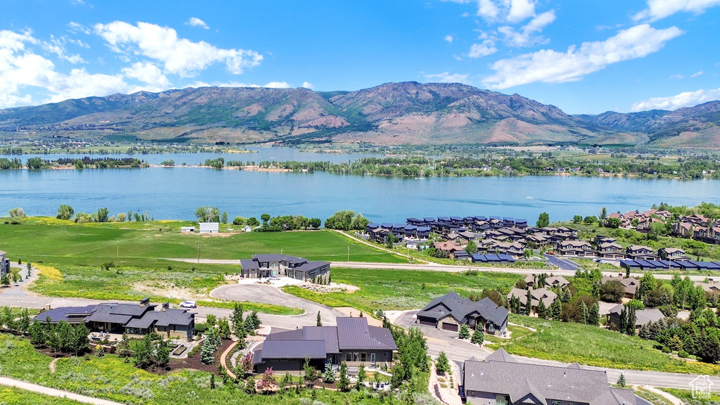 Aerial view of residential area featuring a water and mountain view