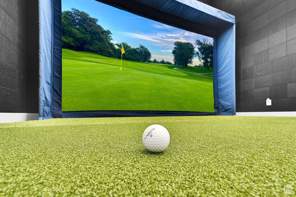 Playroom featuring golf course view and golf simulator