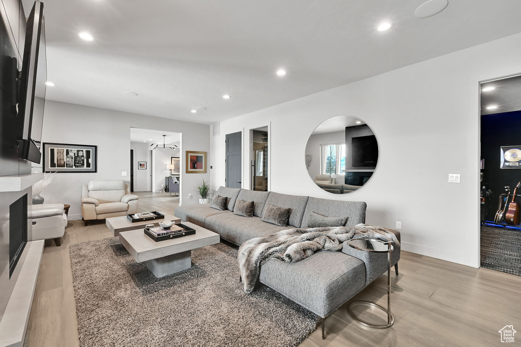 Living room featuring light wood finished floors, recessed lighting, and baseboards