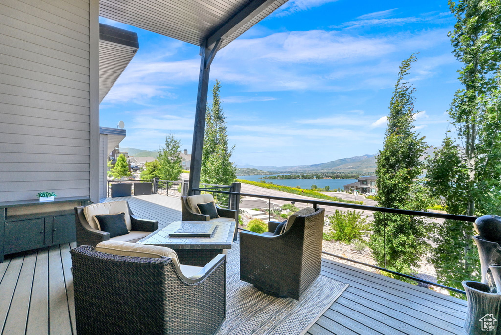 Deck featuring a water and mountain view