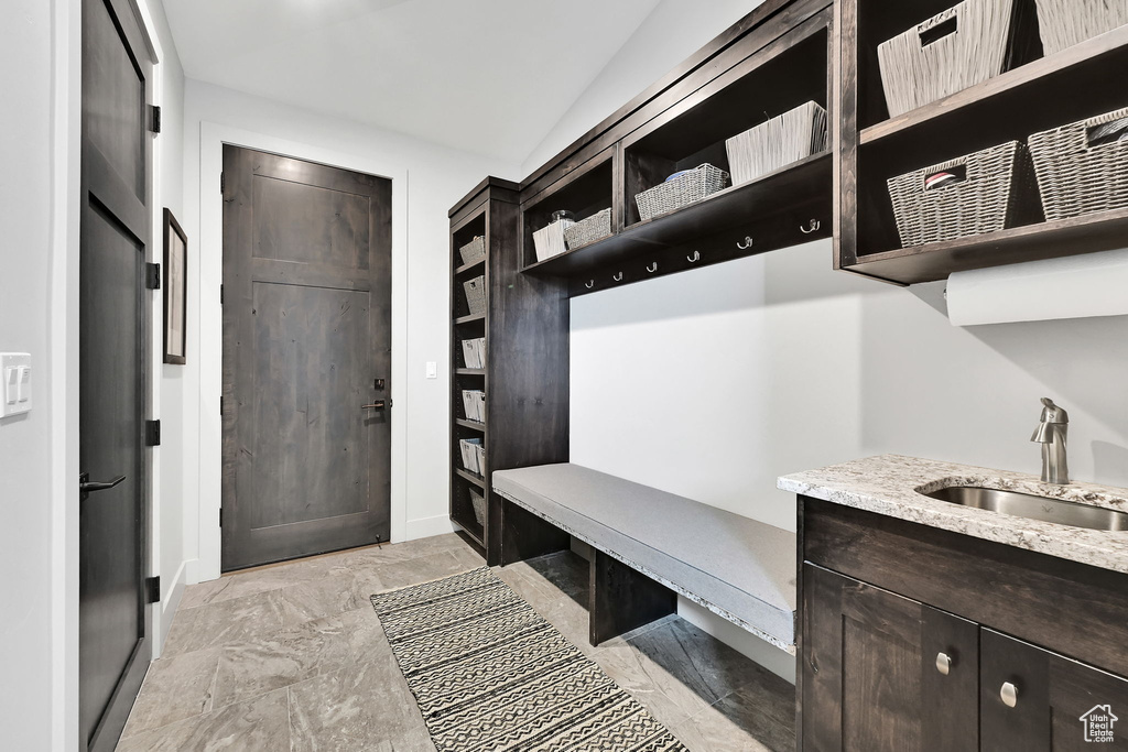 Mudroom featuring a sink and light marble finish flooring