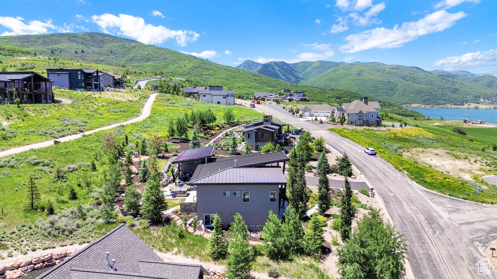 Aerial view of residential area featuring a water and mountain view