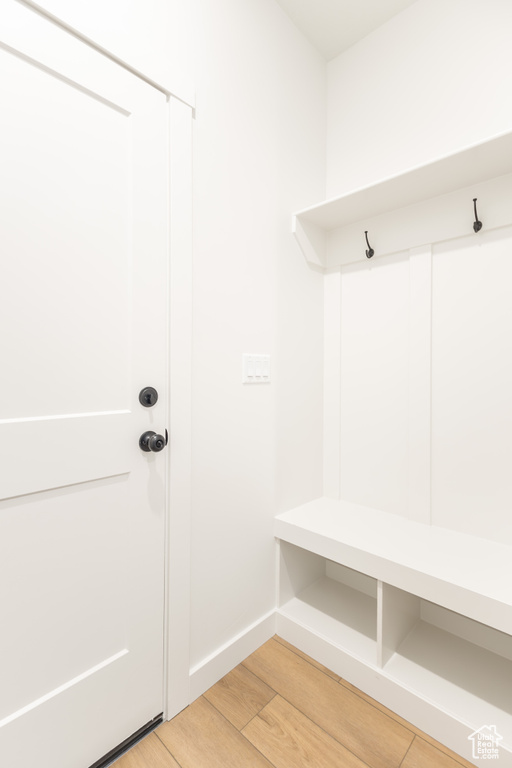 Mudroom featuring light wood-type flooring and baseboards
