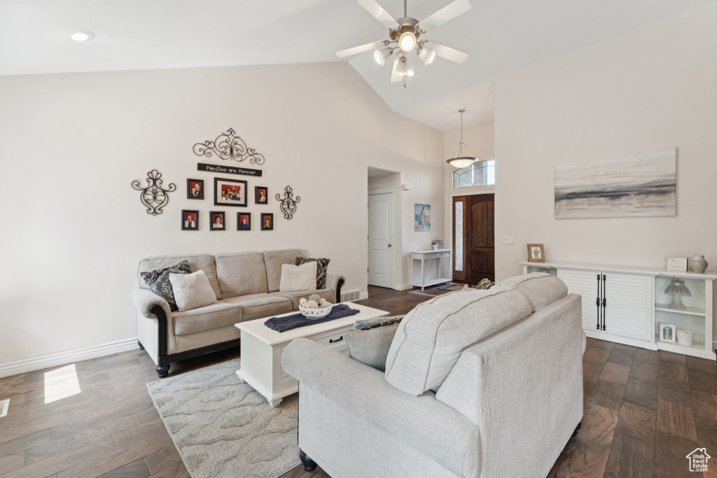 Living room with ceiling fan, high vaulted ceiling, dark wood-style floors, recessed lighting, and baseboards