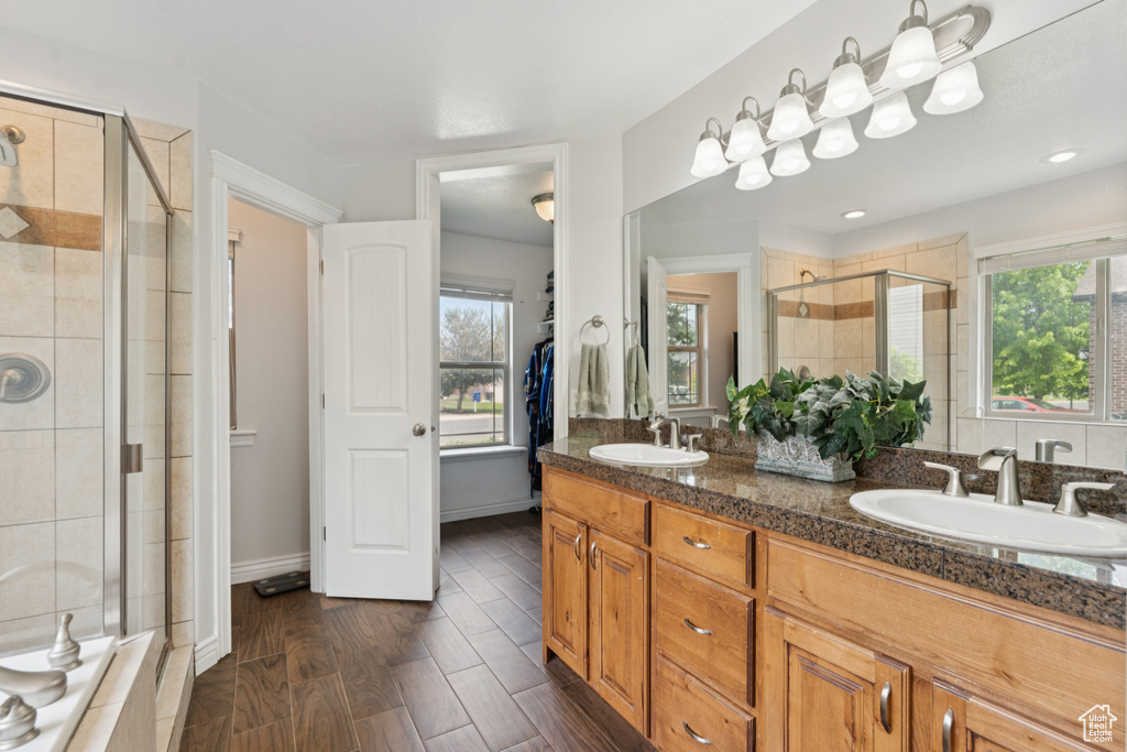 Bathroom with a shower stall and double vanity