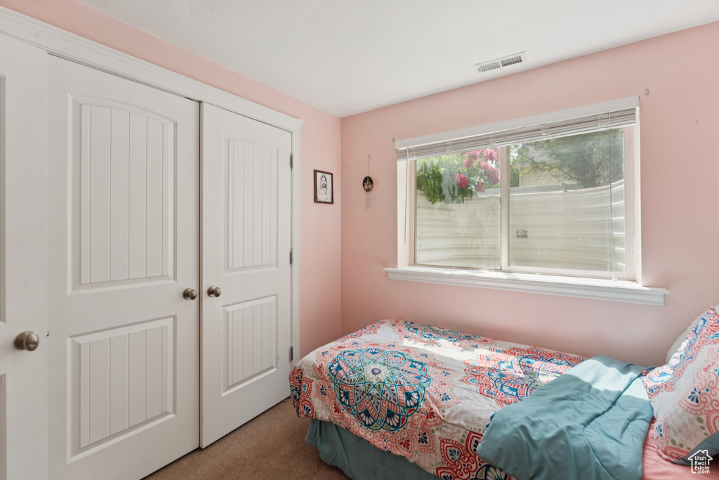 Bedroom with carpet floors and a closet