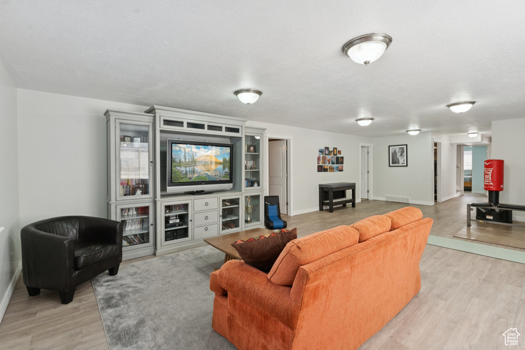 Living area featuring light wood-style flooring and baseboards