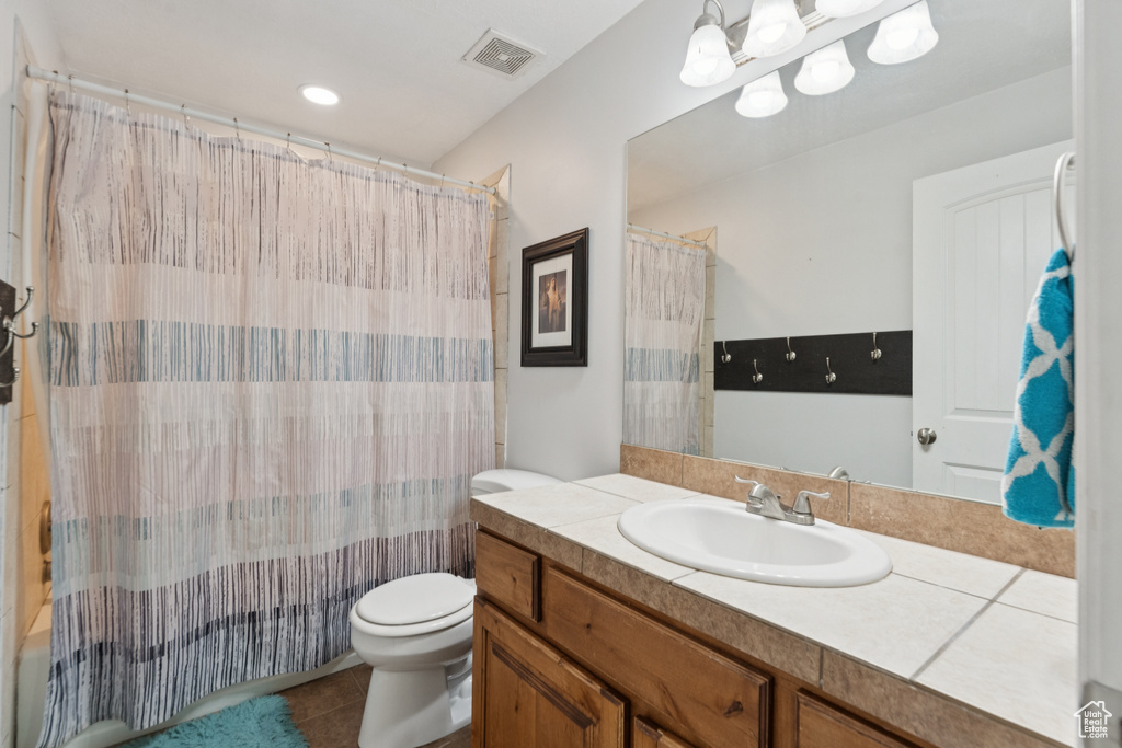 Full bath with toilet, vanity, tile patterned flooring, and a shower with shower curtain