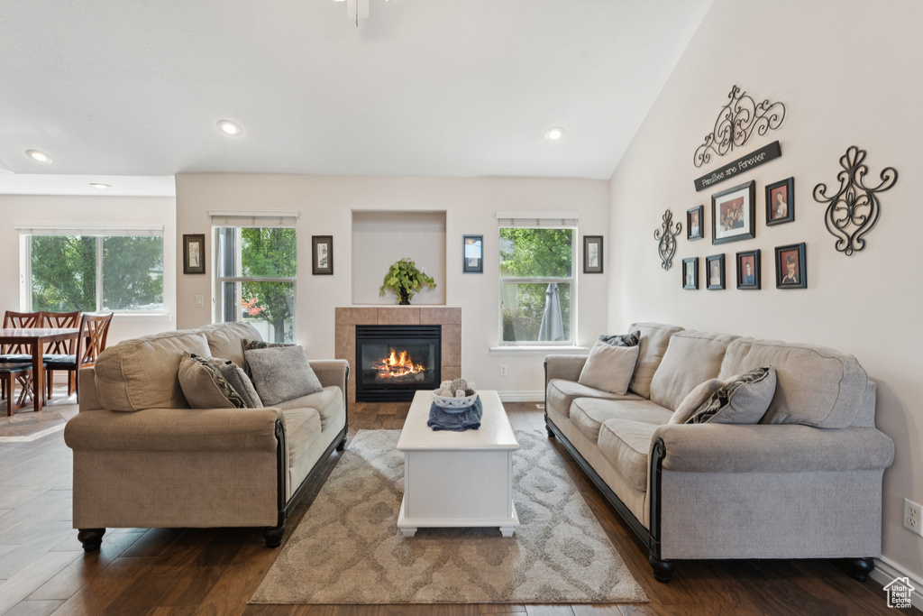 Living area with dark wood-style floors, a fireplace, recessed lighting, and baseboards