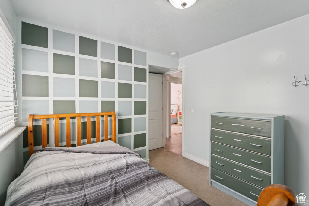Bedroom with carpet floors and multiple windows