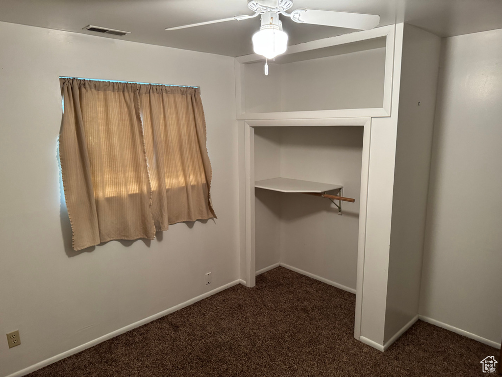 Unfurnished bedroom featuring carpet, baseboards, and a ceiling fan