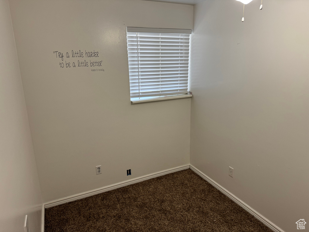 Carpeted spare room with baseboards