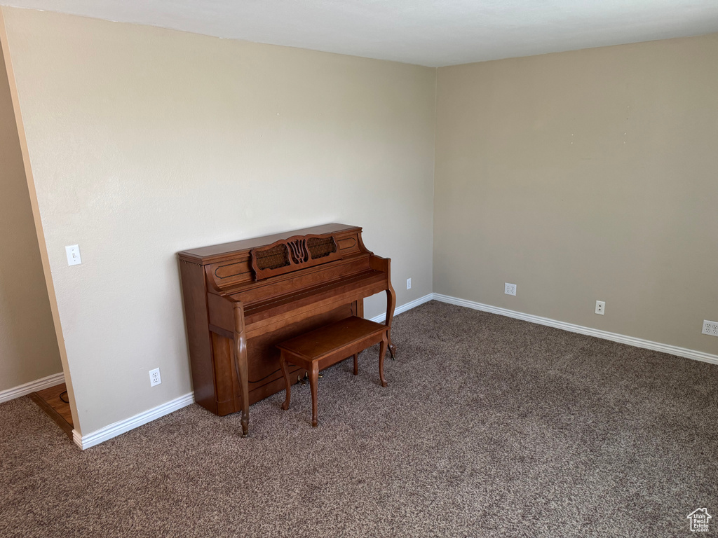 Living area with carpet floors and baseboards