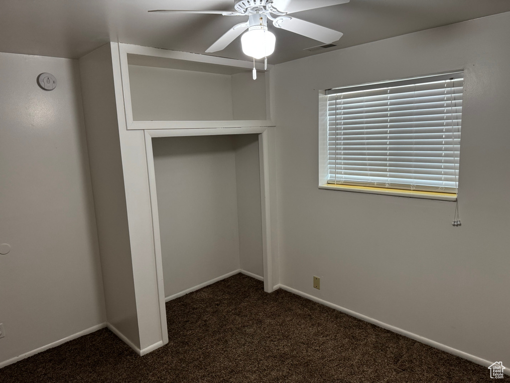 Unfurnished bedroom with carpet, baseboards, a closet, and ceiling fan