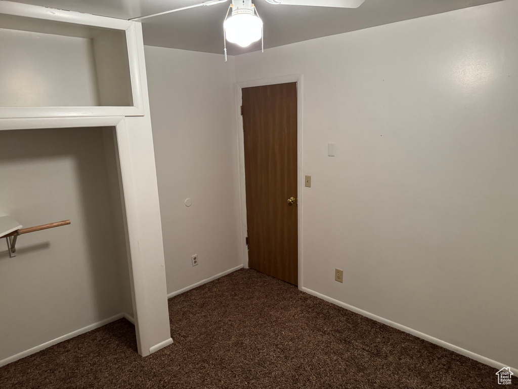 Unfurnished bedroom featuring carpet floors, baseboards, and ceiling fan