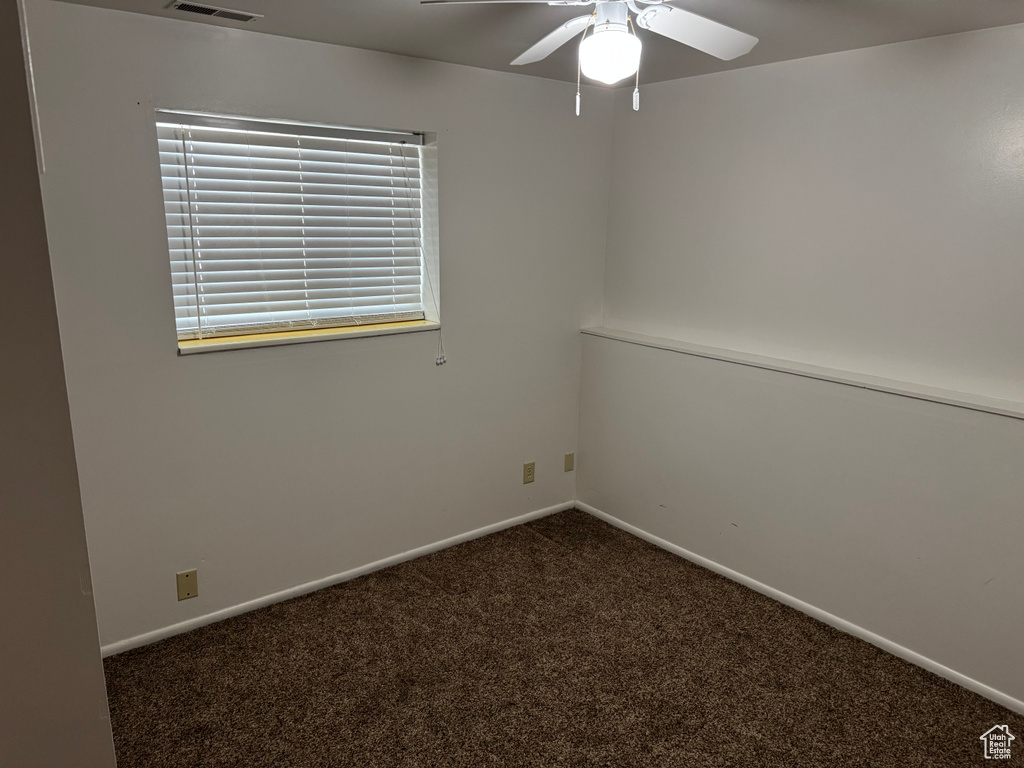 Empty room with carpet floors, baseboards, and ceiling fan