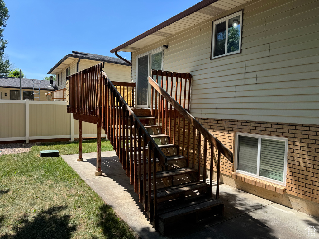 Property entrance with brick siding and a patio
