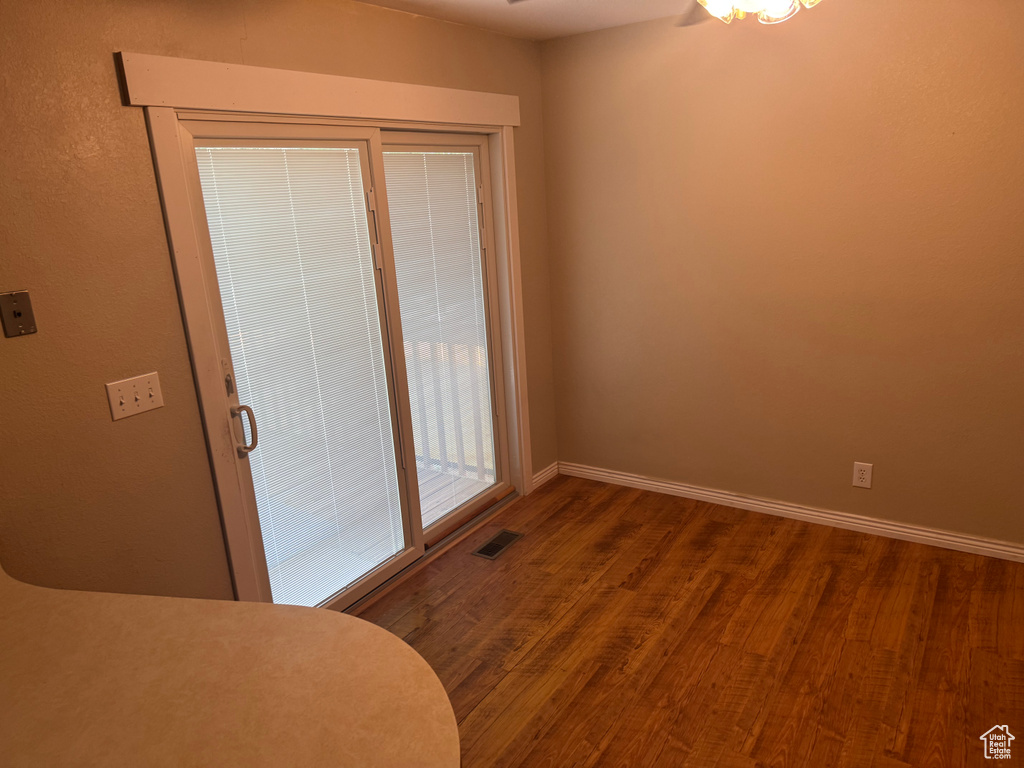Unfurnished dining area with a ceiling fan, wood finished floors, and baseboards
