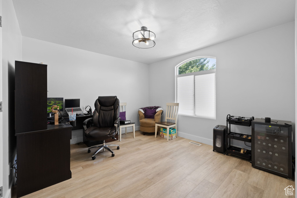 Home office with wood finished floors and baseboards