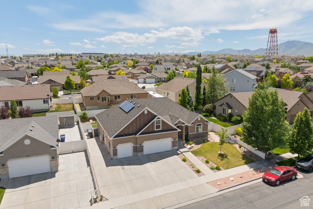 Aerial view of residential area featuring a mountain backdrop
