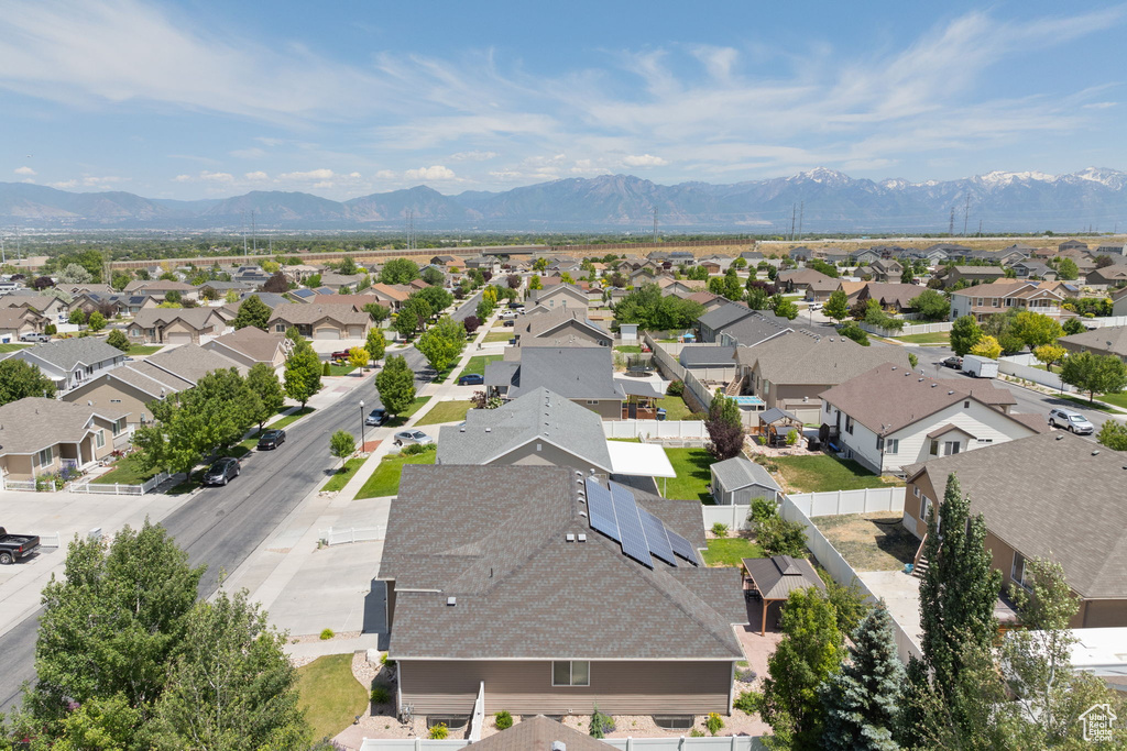 Aerial view of residential area featuring a mountainous background
