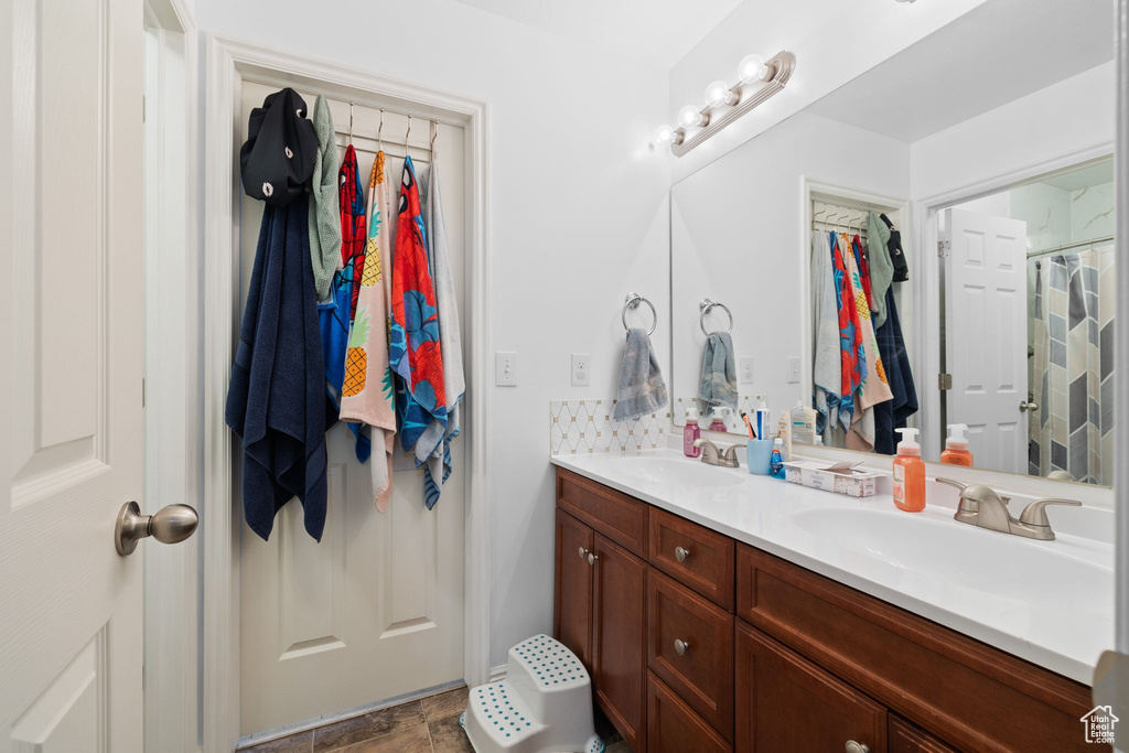 Full bath featuring double vanity
