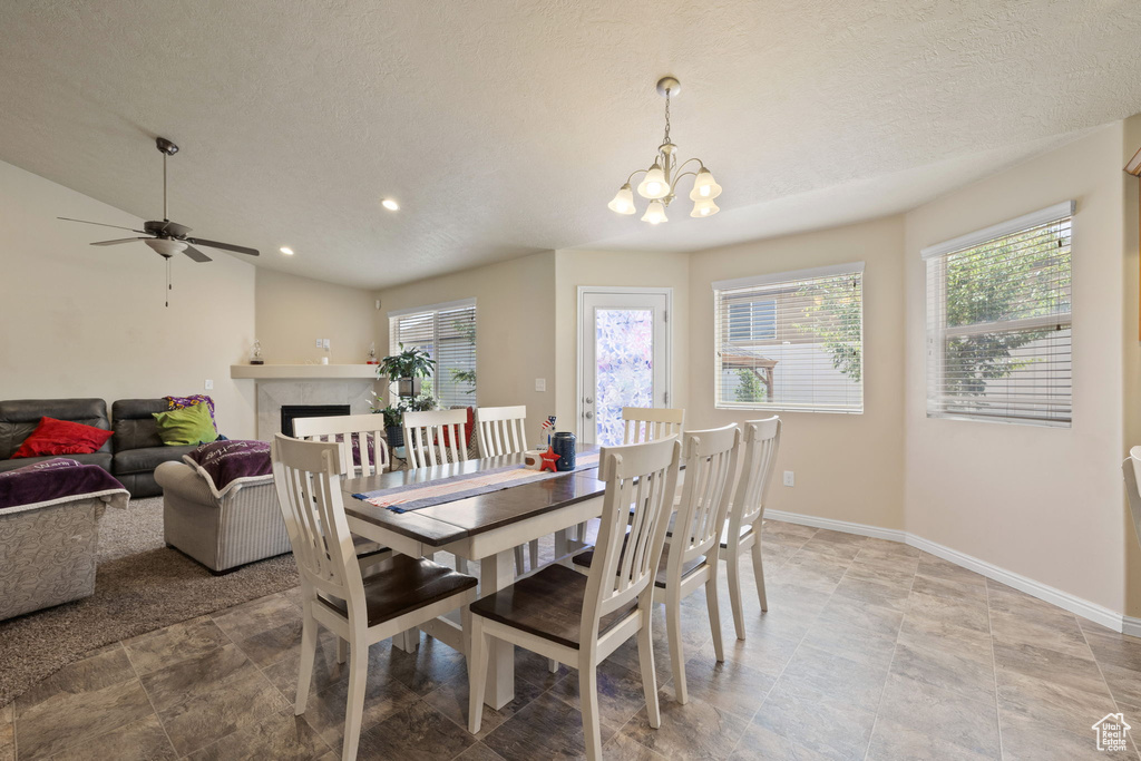 Dining space with plenty of natural light, a chandelier, baseboards, a ceiling fan, and recessed lighting