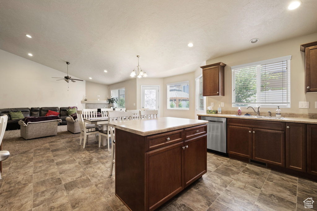 Kitchen featuring stainless steel dishwasher, a sink, recessed lighting, light countertops, and a chandelier