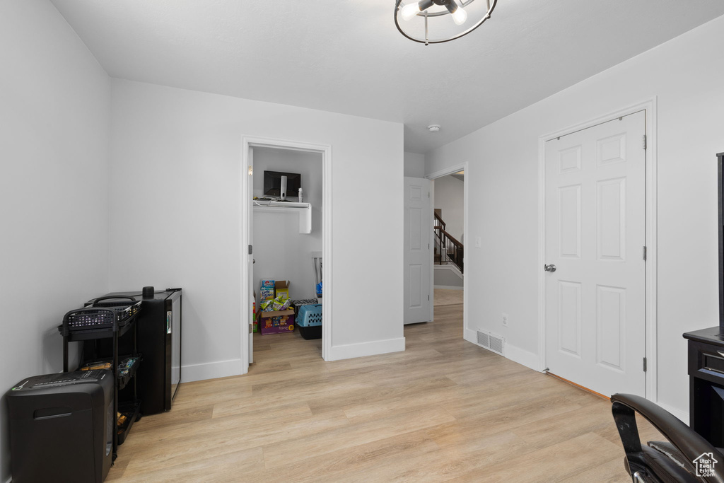 Home office featuring light wood-style floors and baseboards