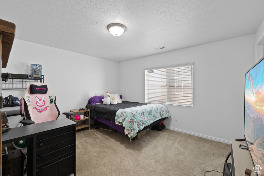 Carpeted bedroom featuring baseboards