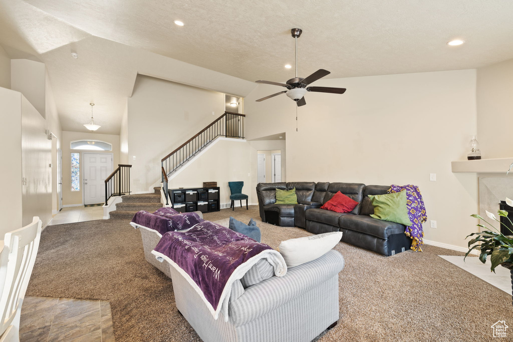 Living area with carpet flooring, stairway, recessed lighting, ceiling fan, and baseboards