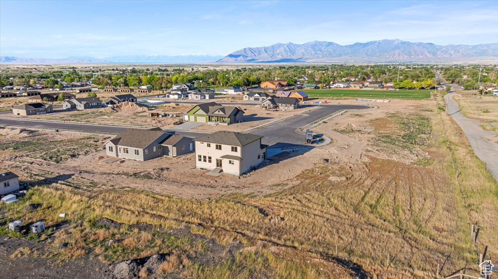 Aerial view of property and surrounding area with a mountainous background