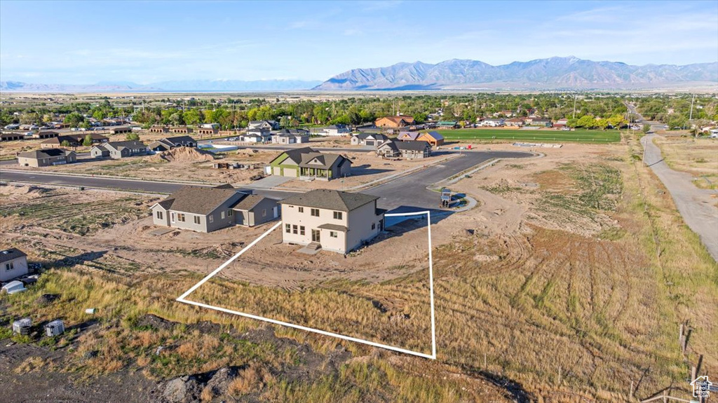 View from above of property featuring property parcel outlined and a mountainous background
