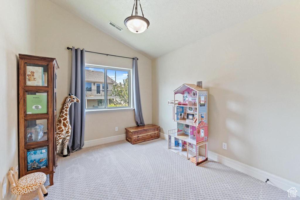Game room featuring lofted ceiling, carpet floors, and baseboards
