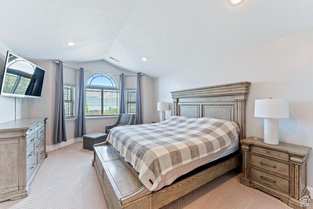 Bedroom featuring lofted ceiling, light colored carpet, baseboards, and recessed lighting