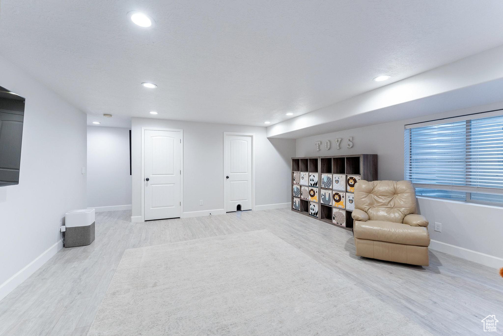 Sitting room featuring wood finished floors, recessed lighting, and baseboards