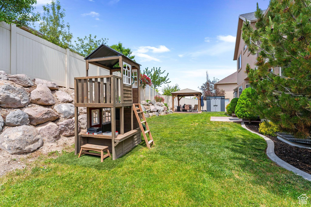View of yard featuring a gazebo and a playground
