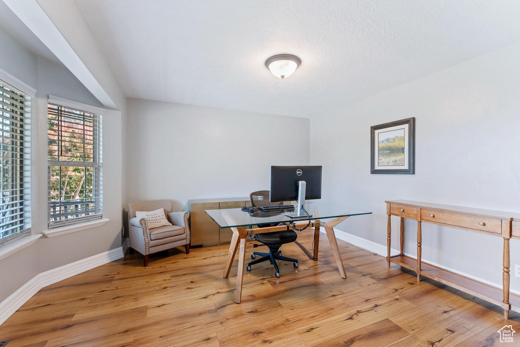 Home office featuring light wood-style floors and baseboards