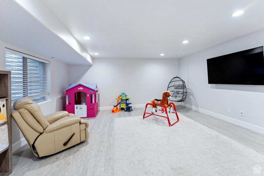Recreation room featuring wood finished floors, recessed lighting, and baseboards