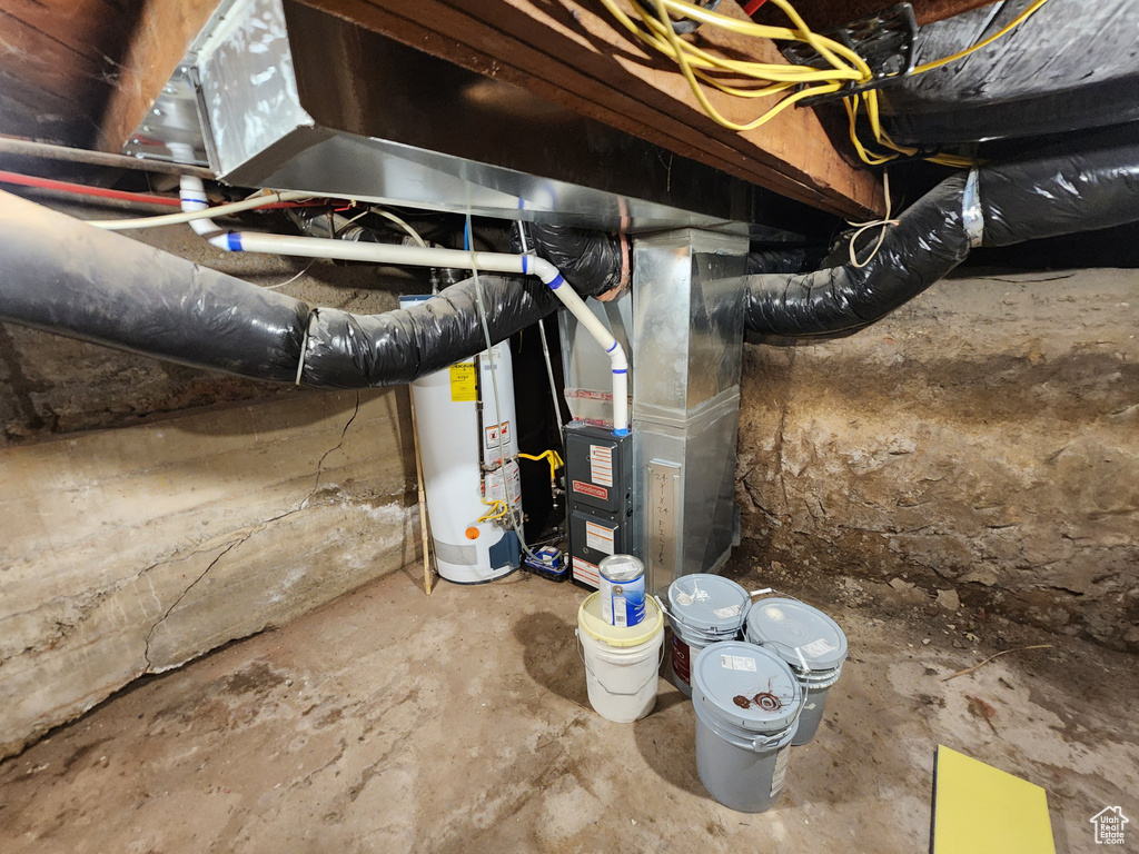 Unfinished basement featuring water heater and heating unit