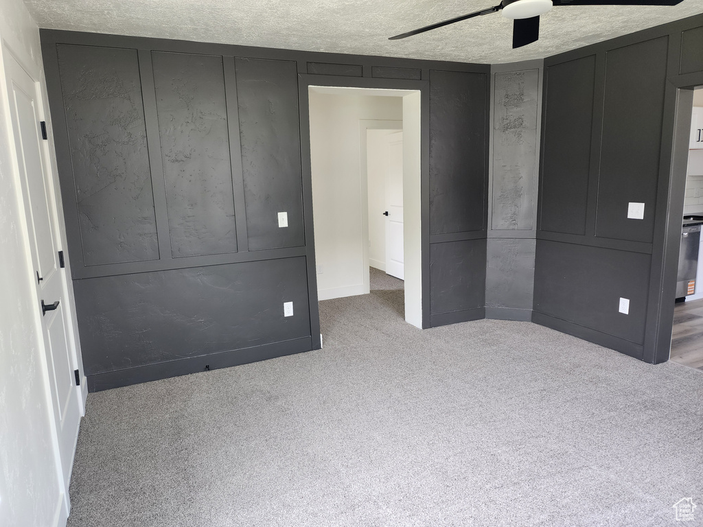 Unfurnished bedroom featuring carpet floors, ceiling fan, and baseboards