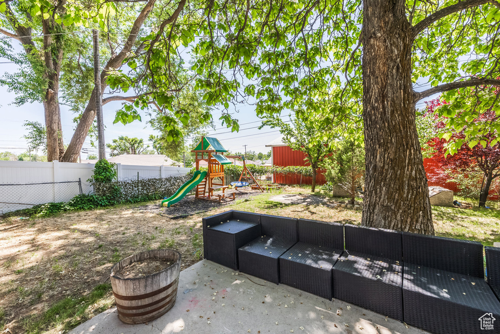 View of yard with a playground, an outdoor living space, and a patio