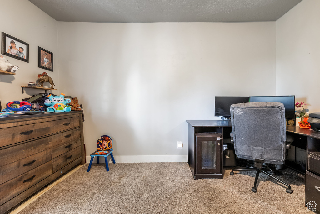 Office area featuring carpet and baseboards