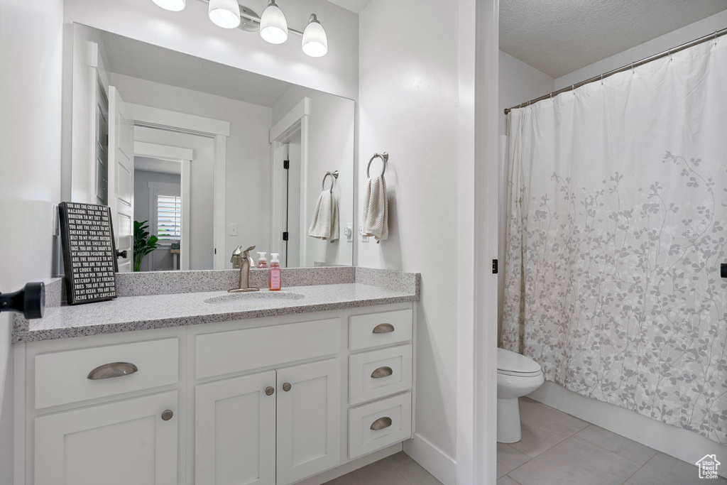 Full bath with vanity, toilet, tile patterned flooring, and a shower with curtain