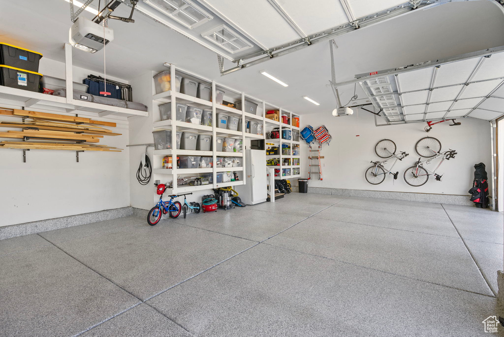 Garage with a garage door opener and baseboards