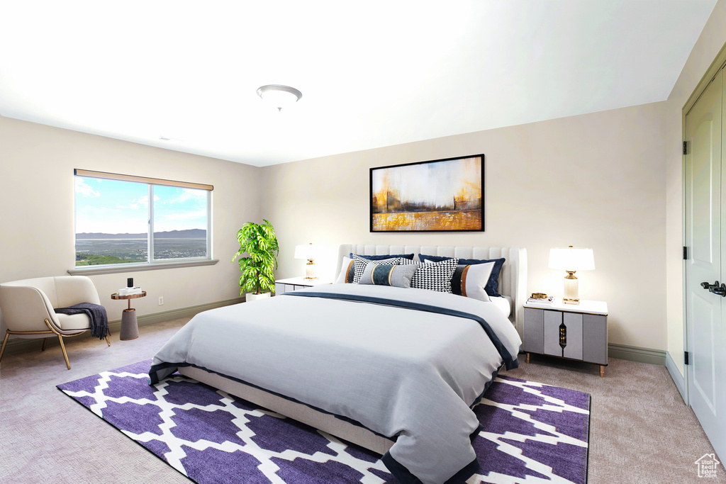 Bedroom with light colored carpet and baseboards