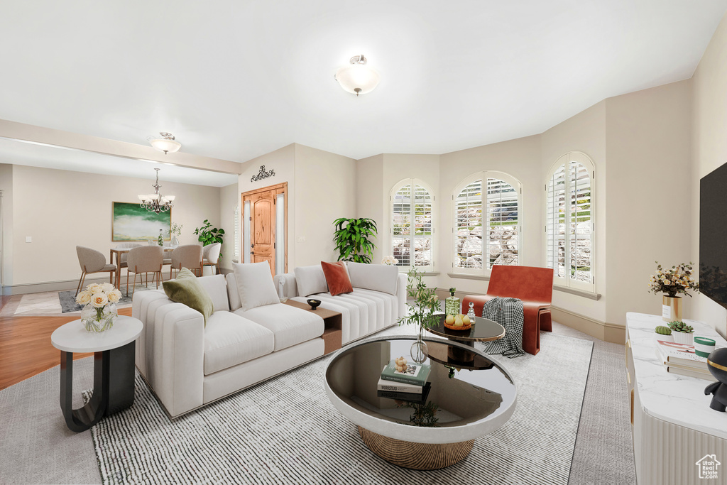 Living area featuring a chandelier and baseboards