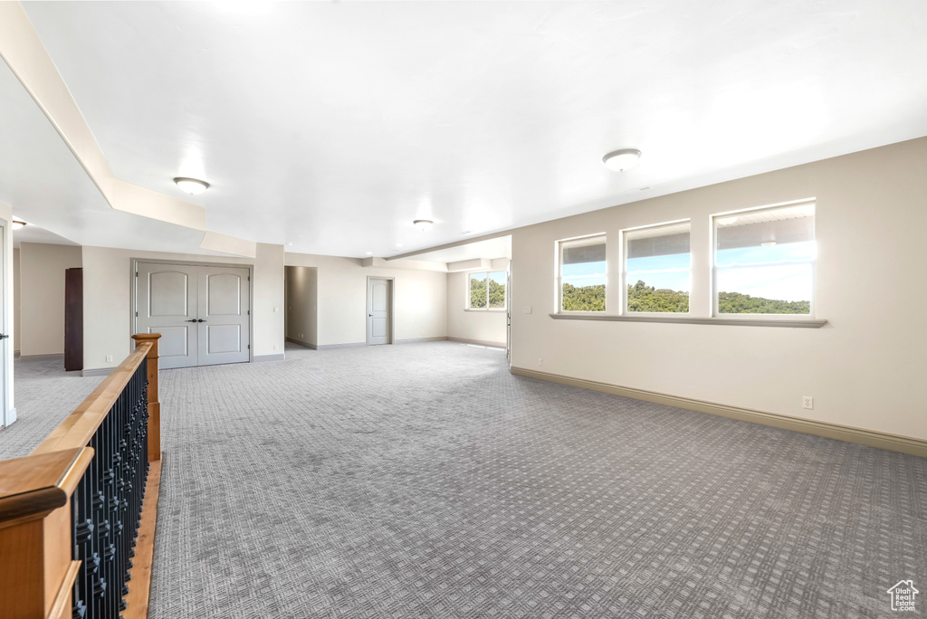 Empty room with carpet flooring and baseboards